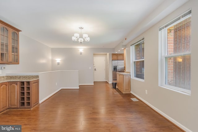 1458 Columbia Rd NW Unit 109, Washington, DC 20009 - unfurnished living room with a chandelier and wood finished floors