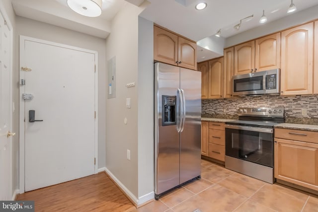 1458 Columbia Rd NW Unit 109, Washington, DC 20009 - kitchen featuring appliances with stainless steel finishes, light brown cabinets, tasteful backsplash, light stone countertops, and light tile patterned flooring