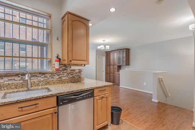 1458 Columbia Rd NW Unit 109, Washington, DC 20009 - kitchen with stainless steel dishwasher, light wood-style flooring, light stone countertops, tasteful backsplash, and a chandelier