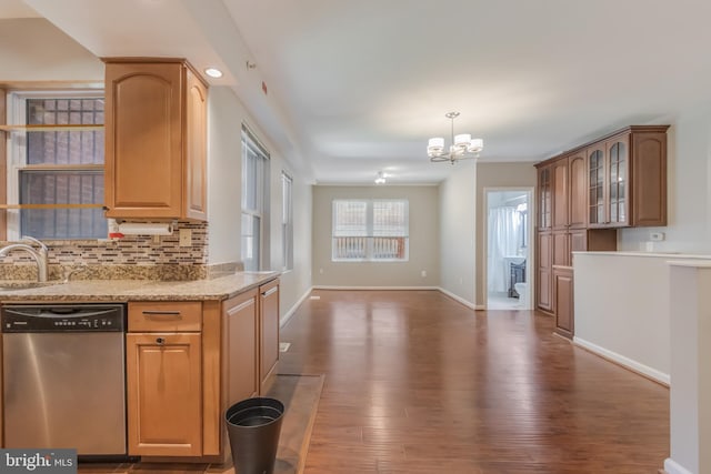 1458 Columbia Rd NW Unit 109, Washington, DC 20009 - kitchen with stainless steel dishwasher, a chandelier, decorative backsplash, wood finished floors, and light stone countertops