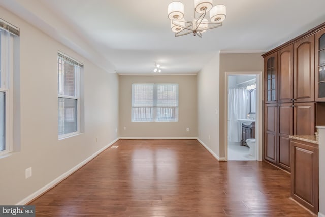 1458 Columbia Rd NW Unit 109, Washington, DC 20009 - unfurnished dining area featuring dark wood-style flooring, a chandelier, plenty of natural light, and ornamental molding