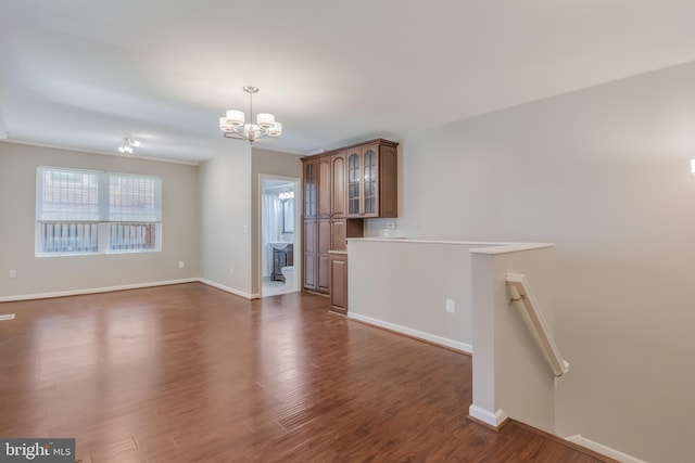 1458 Columbia Rd NW Unit 109, Washington, DC 20009 - unfurnished living room with a chandelier and dark wood-style flooring