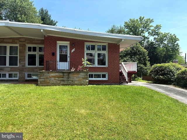 1233 Knightswood Rd, Baltimore, MD 21239 - view of front facade with a front yard and stone siding