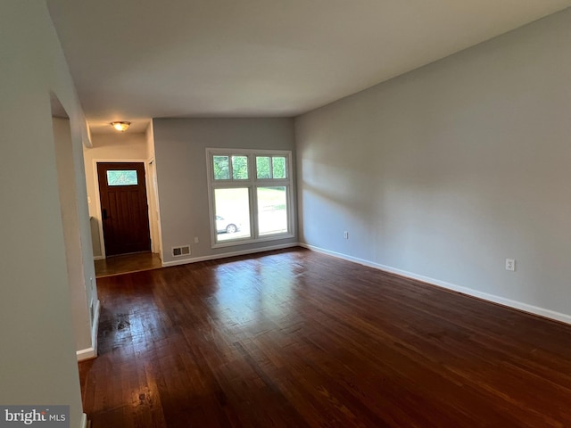 1233 Knightswood Rd, Baltimore, MD 21239 - unfurnished living room featuring dark wood-style floors and baseboards