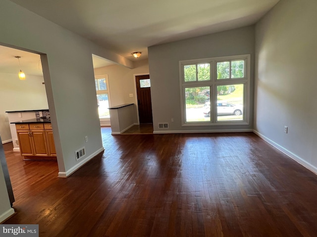1233 Knightswood Rd, Baltimore, MD 21239 - unfurnished living room featuring dark wood-type flooring and baseboards