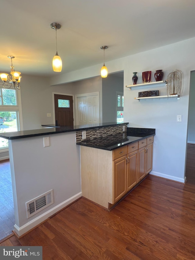 1233 Knightswood Rd, Baltimore, MD 21239 - kitchen featuring dark wood-style flooring, a chandelier, and dark countertops