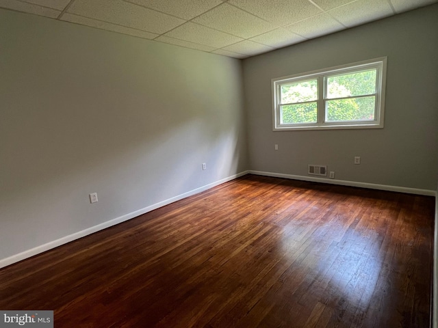 1233 Knightswood Rd, Baltimore, MD 21239 - unfurnished room featuring dark wood-style flooring and a paneled ceiling