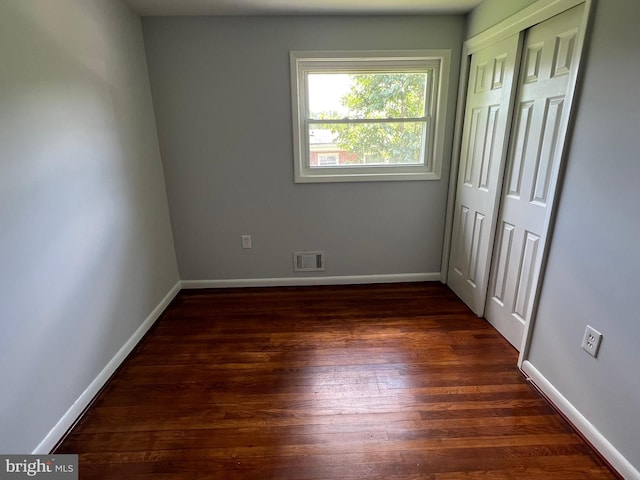1233 Knightswood Rd, Baltimore, MD 21239 - unfurnished bedroom featuring dark wood-style flooring and a closet
