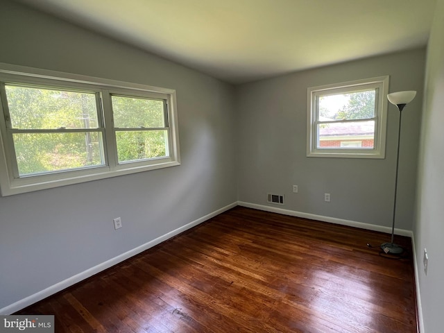 1233 Knightswood Rd, Baltimore, MD 21239 - empty room with healthy amount of natural light, wood finished floors, and vaulted ceiling