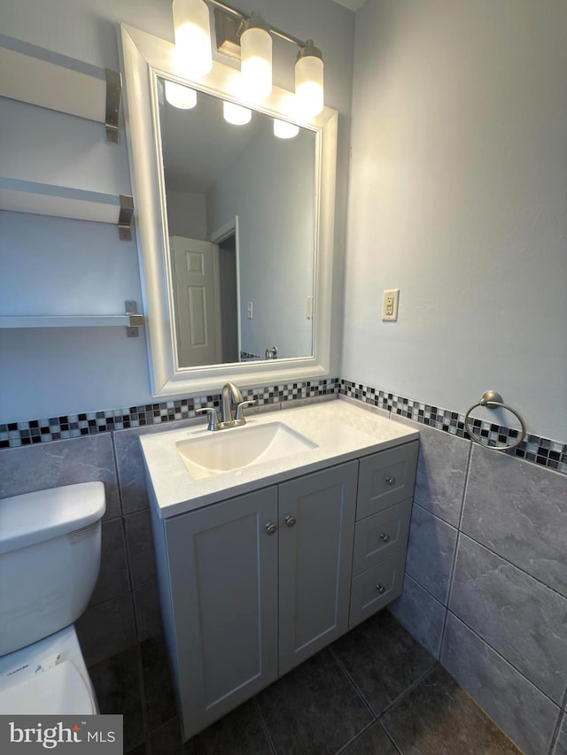 1233 Knightswood Rd, Baltimore, MD 21239 - half bathroom featuring tile walls, vanity, tile patterned floors, and a wainscoted wall