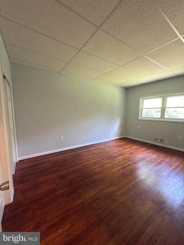 1233 Knightswood Rd, Baltimore, MD 21239 - spare room with dark wood-type flooring and a drop ceiling