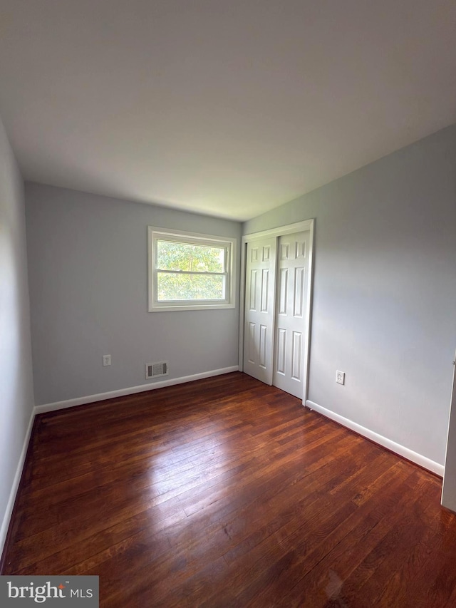 1233 Knightswood Rd, Baltimore, MD 21239 - unfurnished bedroom with wood finished floors and a closet