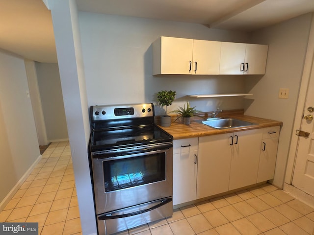 1233 Knightswood Rd, Baltimore, MD 21239 - kitchen featuring stainless steel electric stove, light tile patterned floors, and white cabinets
