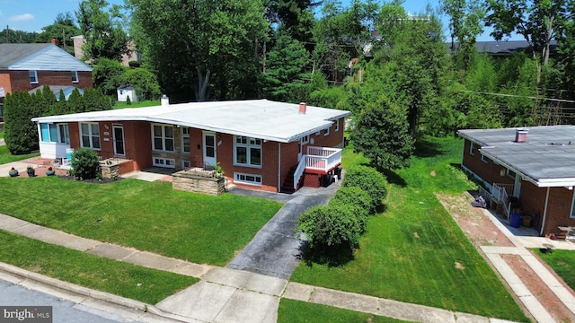 1233 Knightswood Rd, Baltimore, MD 21239 - view of front of property featuring asphalt driveway, brick siding, and a front lawn