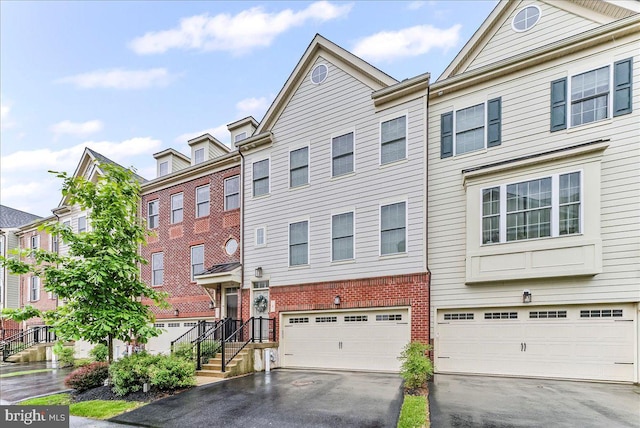 4 Parkview Cir, Wayne, PA 19087 - multi unit property featuring asphalt driveway, brick siding, a garage, and a residential view