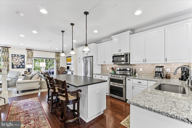 4 Parkview Cir, Wayne, PA 19087 - kitchen with stainless steel appliances, dark wood-style floors, tasteful backsplash, white cabinetry, and recessed lighting