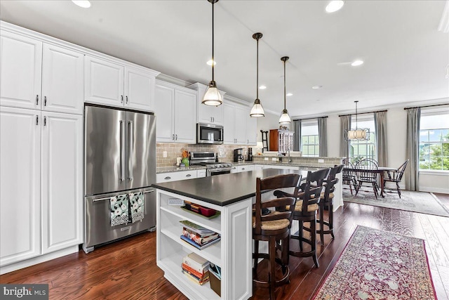 4 Parkview Cir, Wayne, PA 19087 - kitchen with stainless steel appliances, a center island, white cabinets, backsplash, and dark wood-style flooring