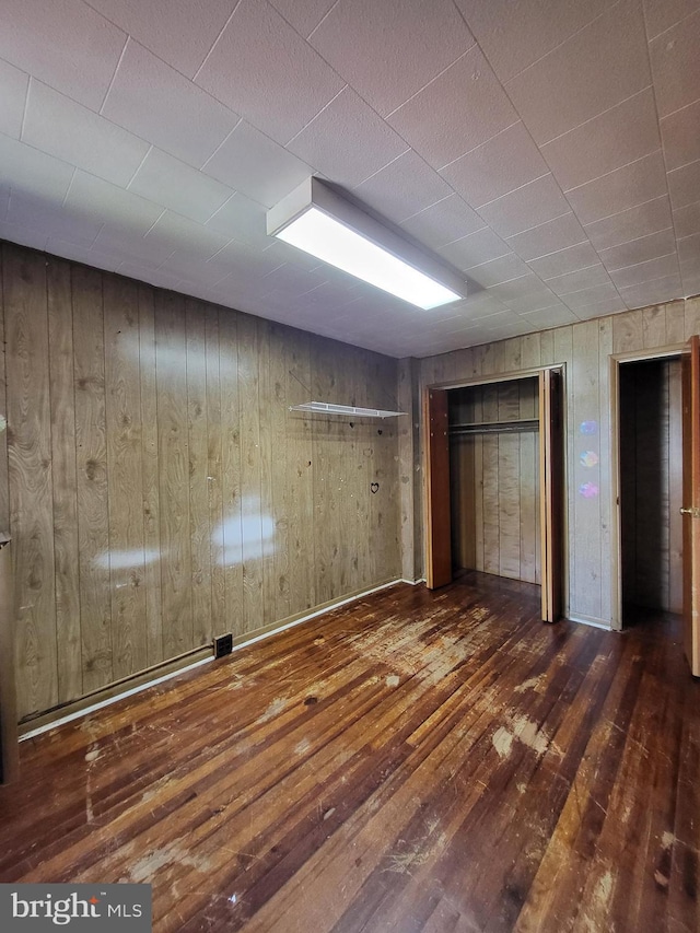 542 S 14 1/2 St, Reading, PA 19602 - unfurnished bedroom with hardwood / wood-style flooring and wooden walls