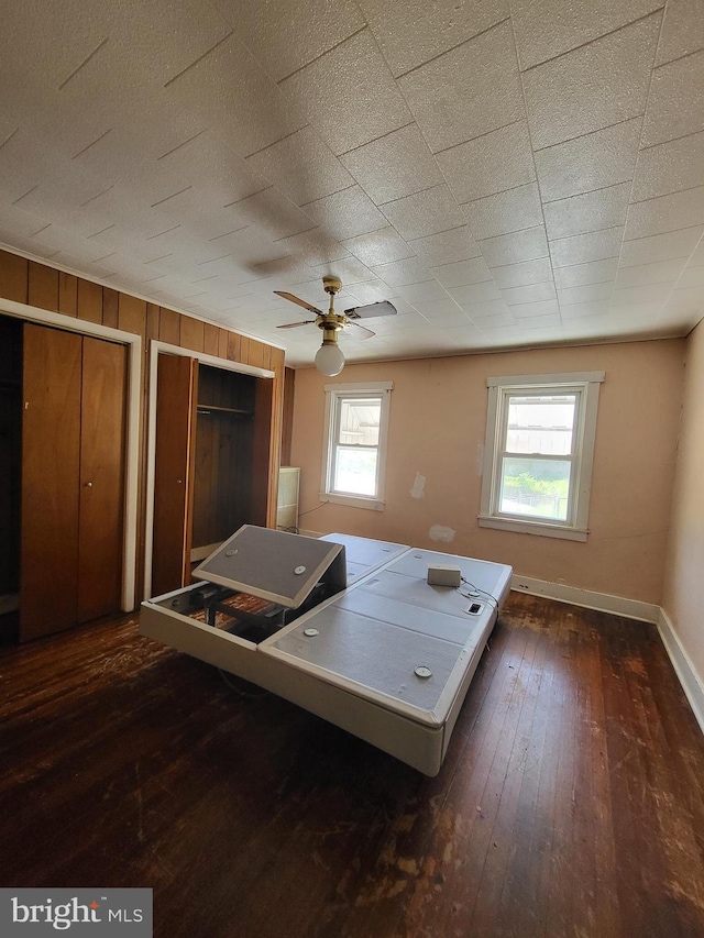 542 S 14 1/2 St, Reading, PA 19602 - bedroom with dark wood-style floors, multiple closets, a ceiling fan, and a desk