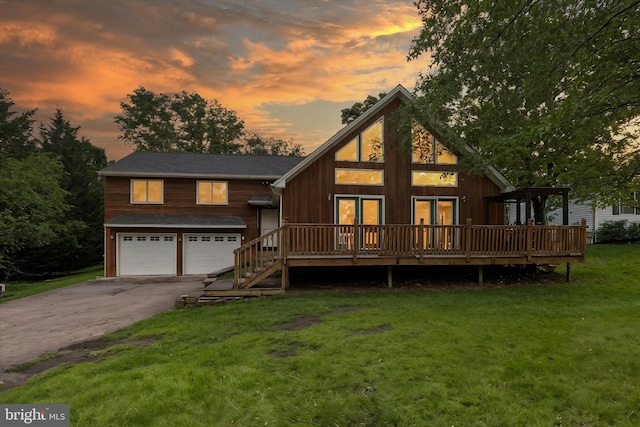 4 Johnson Dr, East Berlin, PA 17316 - back of house at dusk with an attached garage, a deck, a yard, and asphalt driveway