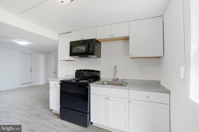 1221 W Heiges St, York, PA 17404 - kitchen featuring black appliances, light countertops, and white cabinets