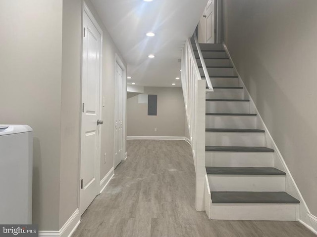 224 N Rose St, Baltimore, MD 21224 - stairway with washer / clothes dryer, wood finished floors, and recessed lighting