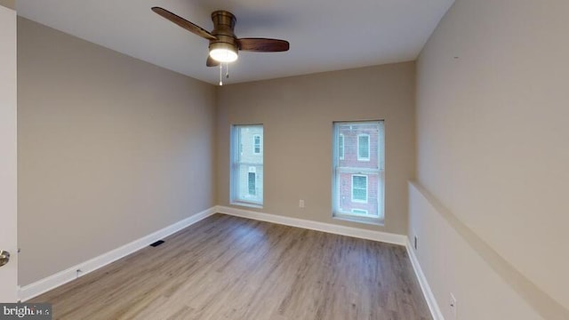 224 N Rose St, Baltimore, MD 21224 - empty room with wood finished floors and ceiling fan