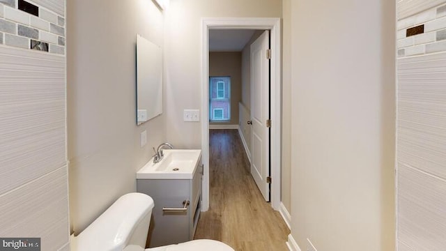224 N Rose St, Baltimore, MD 21224 - bathroom featuring wood finished floors, vanity, and a heating unit
