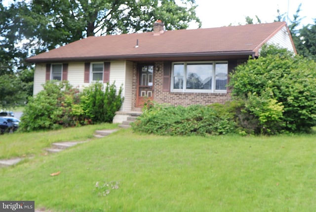 701 Tamarack Trl, Reading, PA 19607 - single story home with a chimney, a front yard, and brick siding