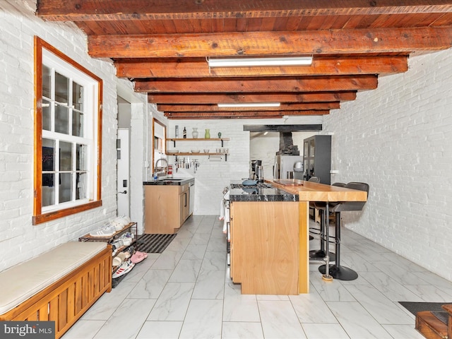23 W 5th St, Frederick, MD 21701 - bar area featuring light marble finish flooring, a wooden ceiling with exposed beams, brick wall, and appliances with stainless steel finishes
