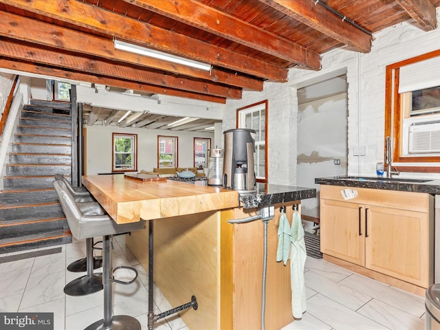 23 W 5th St, Frederick, MD 21701 - kitchen with light marble finish floors, a wooden ceiling with exposed beams, light brown cabinetry, and wooden counters