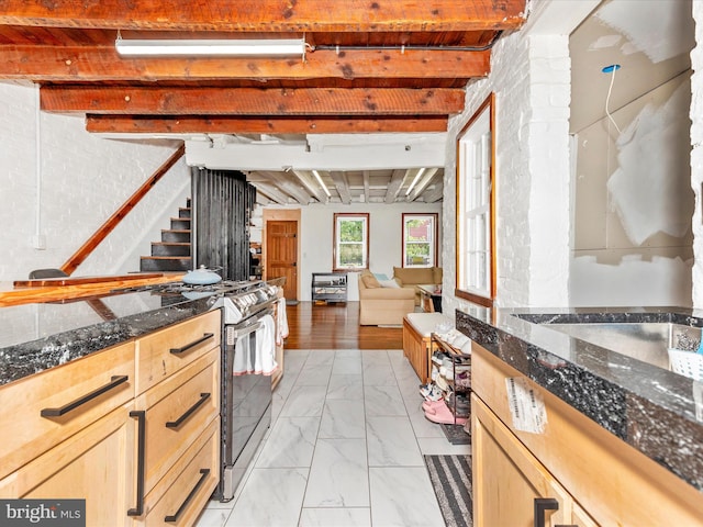 23 W 5th St, Frederick, MD 21701 - kitchen featuring electric stove, light marble finish flooring, beamed ceiling, dark stone countertops, and open floor plan