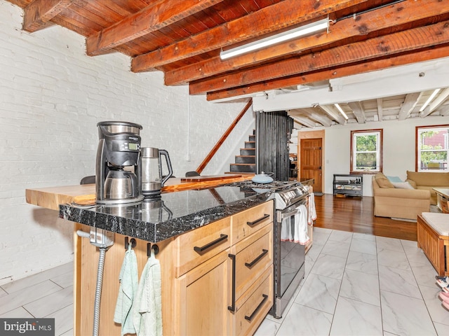 23 W 5th St, Frederick, MD 21701 - kitchen featuring stainless steel range with electric stovetop, light marble finish flooring, open floor plan, a wood ceiling with exposed beams, and dark stone counters