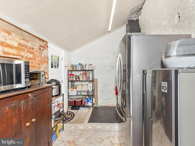 23 W 5th St, Frederick, MD 21701 - kitchen with stainless steel appliances, brick wall, and lofted ceiling
