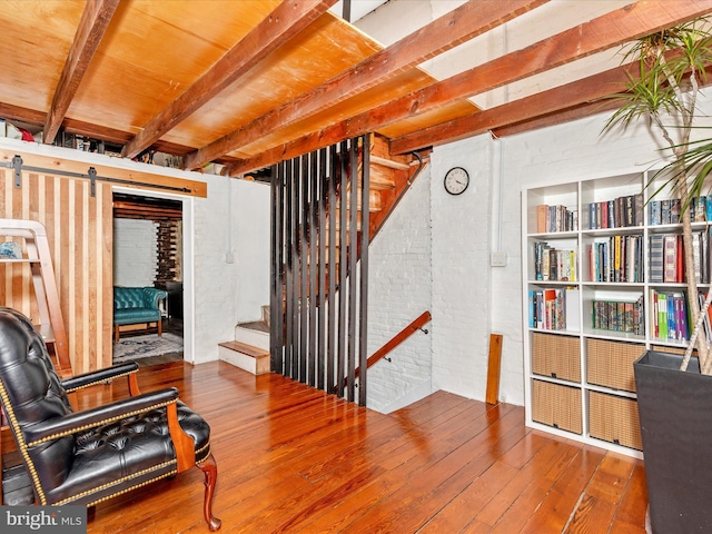23 W 5th St, Frederick, MD 21701 - sitting room with a barn door, hardwood / wood-style flooring, beam ceiling, and stairway