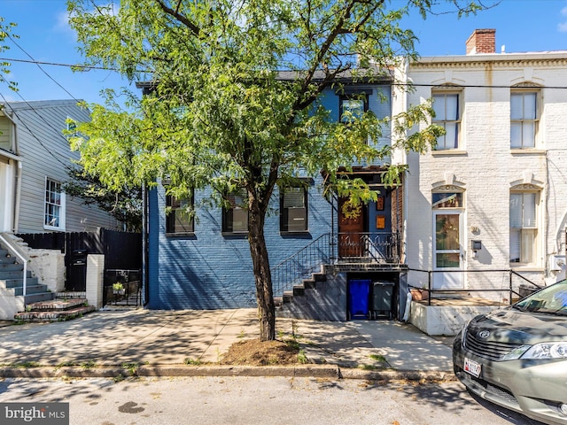 23 W 5th St, Frederick, MD 21701 - view of front of house featuring brick siding and a chimney