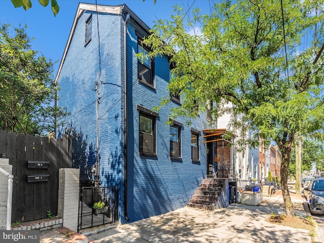 23 W 5th St, Frederick, MD 21701 - view of front of home with a gate and brick siding