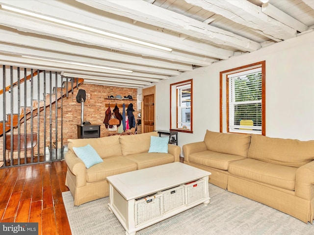 23 W 5th St, Frederick, MD 21701 - living room featuring hardwood / wood-style flooring, beamed ceiling, brick wall, and stairs