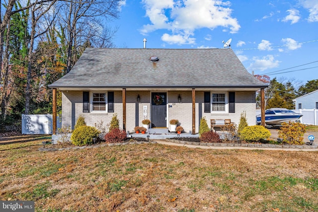 69 Plymouth Rd, Sicklerville, NJ 08081 - view of front of home with brick siding, a front yard, covered porch, and a shingled roof