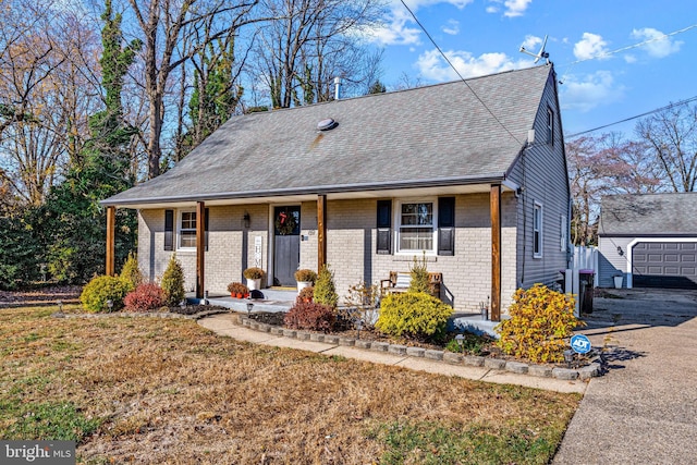 69 Plymouth Rd, Sicklerville, NJ 08081 - view of front of house featuring covered porch, brick siding, roof with shingles, an outbuilding, and a front lawn