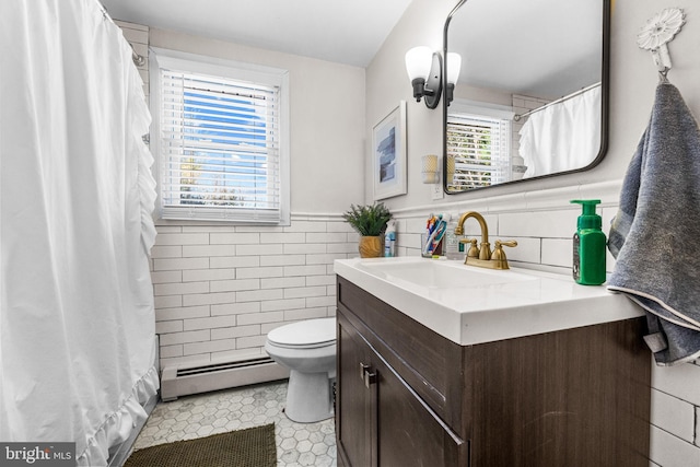 69 Plymouth Rd, Sicklerville, NJ 08081 - bathroom with a baseboard heating unit, tile walls, vanity, tile patterned flooring, and wainscoting