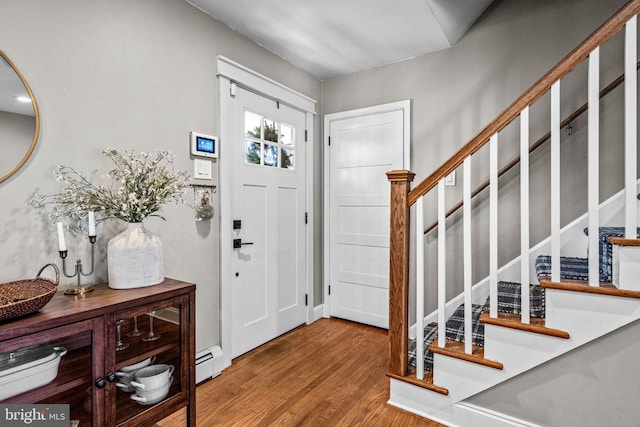 69 Plymouth Rd, Sicklerville, NJ 08081 - entrance foyer with a baseboard heating unit, wood finished floors, and stairs