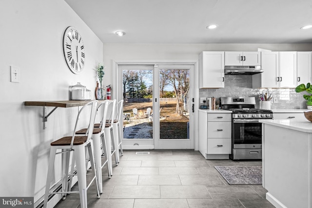 69 Plymouth Rd, Sicklerville, NJ 08081 - kitchen with stainless steel range with gas stovetop, under cabinet range hood, light countertops, tasteful backsplash, and white cabinets