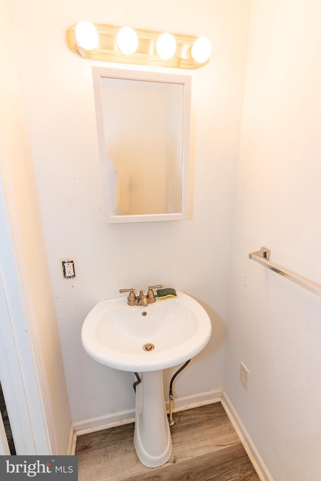 16 S Kresson St, Baltimore, MD 21224 - bathroom featuring wood finished floors and baseboards