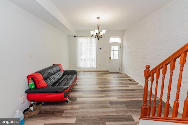 16 S Kresson St, Baltimore, MD 21224 - foyer featuring a chandelier, wood finished floors, and brick wall