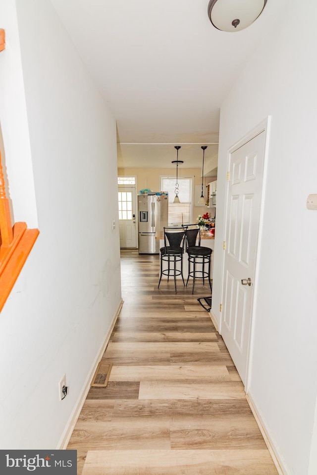 16 S Kresson St, Baltimore, MD 21224 - hall with light wood-style floors and baseboards