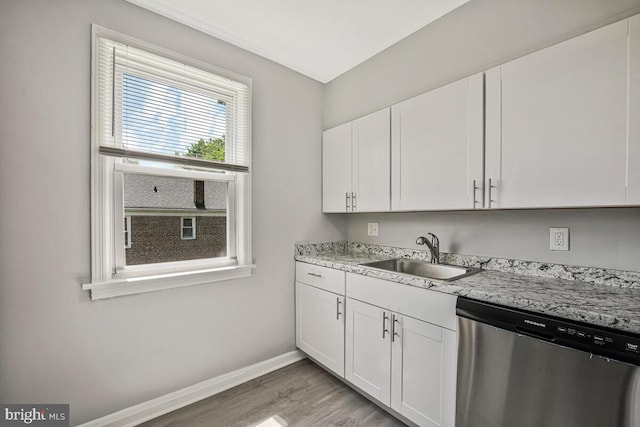 1112 Gleneagle Rd, Baltimore, MD 21239 - kitchen featuring stainless steel dishwasher, white cabinets, and light wood-type flooring