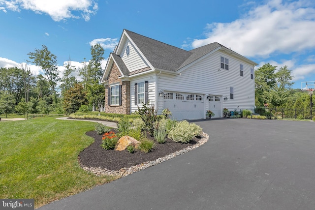 306 Rowland Ln, Line Lexington, PA 18932 - view of side of property featuring an attached garage, driveway, stone siding, and a shingled roof