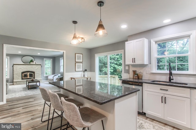 128 Azalea Dr, Hershey, PA 17033 - kitchen featuring dishwasher, white cabinetry, dark stone counters, a center island, and plenty of natural light