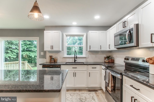 128 Azalea Dr, Hershey, PA 17033 - kitchen with stainless steel appliances, light wood-style flooring, dark stone countertops, white cabinets, and recessed lighting